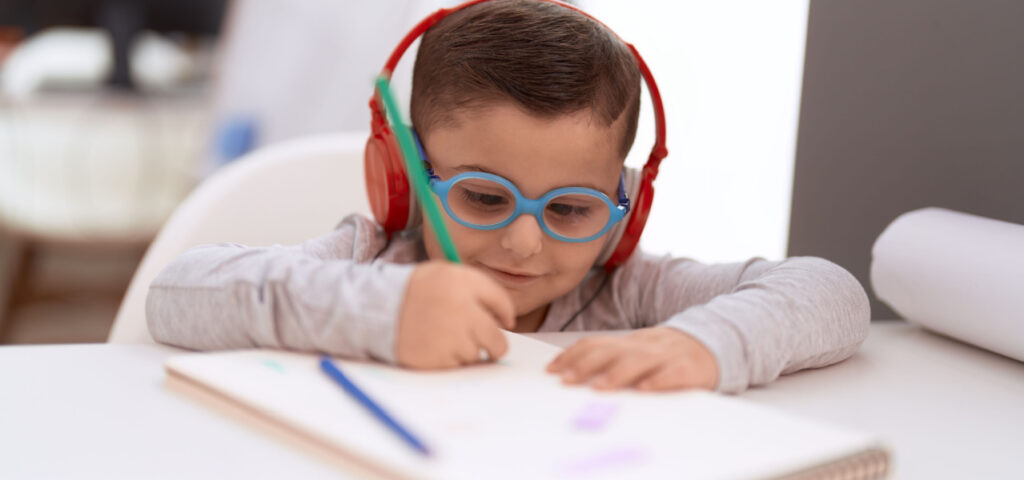 A child writing in a notebook. 