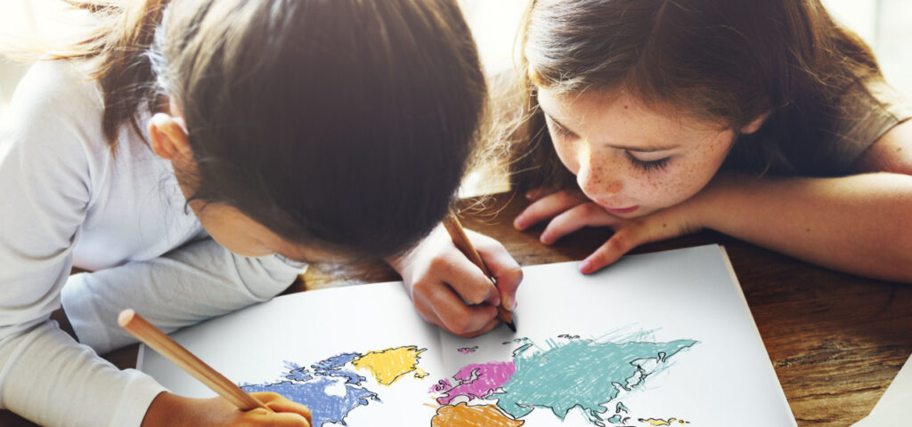 two children coloring a map of the world with pencils