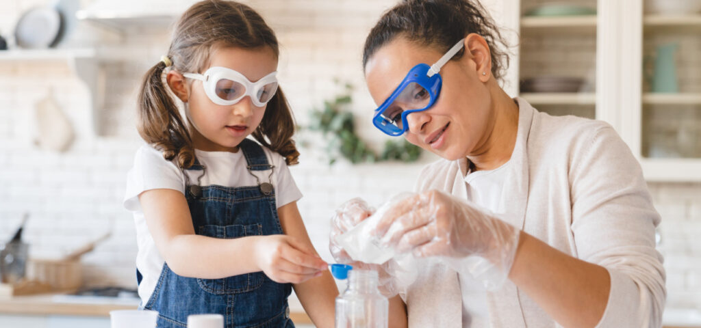 Mother and daughter doing a science experiment together. 