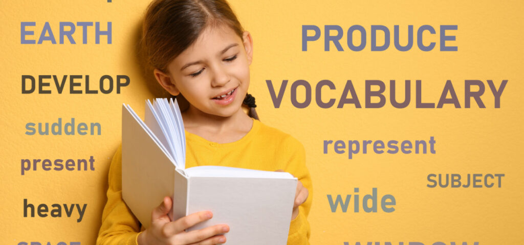 Girl learning to read book with vocab words behind her. 